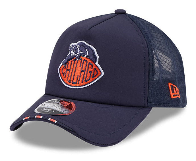 A navy blue Chicago Bears trucker cap by New Era, featuring a structured front panel with the team's bear logo and 'CHICAGO' embroidered in orange and white, mesh back panels, and a small orange New Era logo on the side.