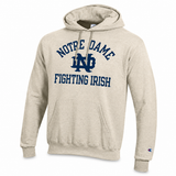A heather beige pullover hoodie featuring a navy blue graphic on the chest that reads 'NOTRE DAME FIGHTING IRISH' with the 'ND' logo in the center. A small Champion logo is visible on the left sleeve cuff.